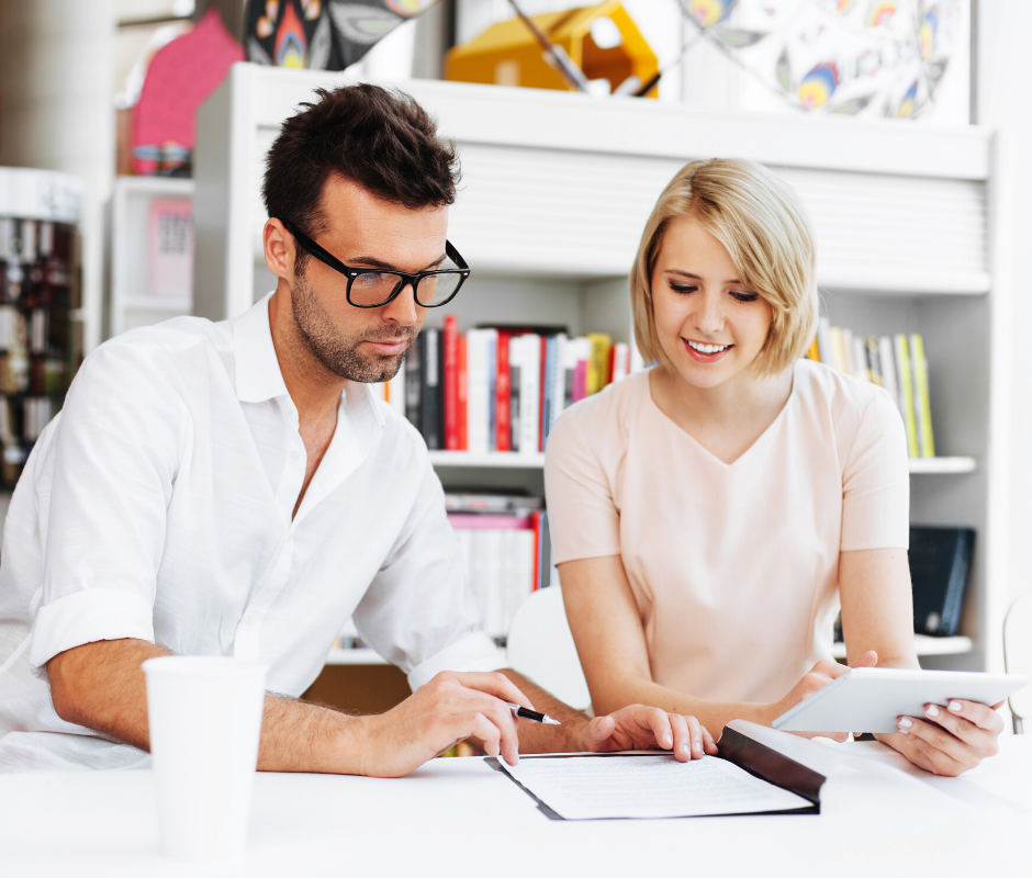 Man and Woman reviewing a document at a table together